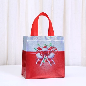 Macro detail of Christmas gift bag with red bow and metallic silver non-woven fabric