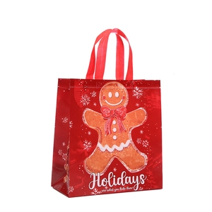 Christmas non-woven gift bag with gingerbread man and snowflake pattern on red base