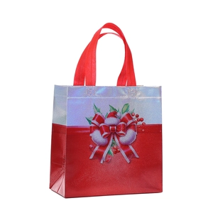 Christmas non-woven gift bag with festive bow and red berry prints for holiday shopping