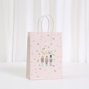 Pink striped Nutcracker Christmas gift bag with white twist handle and gold snowflakes