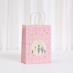 Pink Christmas Nutcracker kraft paper gift bag with handles and Happy Holidays print