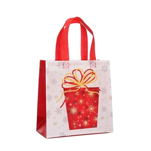 Christmas non-woven gift bag with festive red handles and gold ribbon gift box print