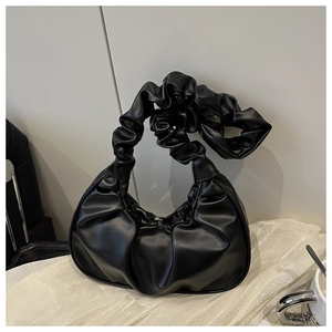Detailed close-up of a black pleated scrunchie cloud bag in smooth premium PU leather