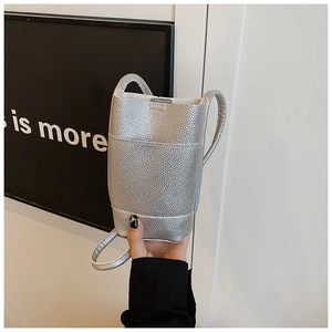 Detail of silver crossbody phone bag with pebble leather texture and slim handle