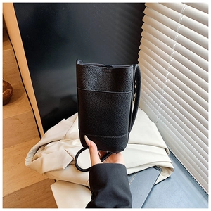 Close-up of black lychee-grain leather mini crossbody bag for summer fashion style