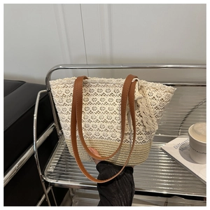Detail of lace and straw patchwork tote bag with brown faux leather shoulder straps