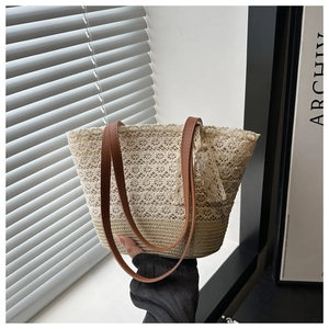 Detail of bohemian tote bag showing crochet floral lace and woven straw texture
