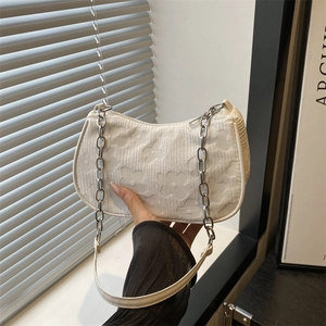 White crescent chain bag with embossed floral texture and double shoulder straps