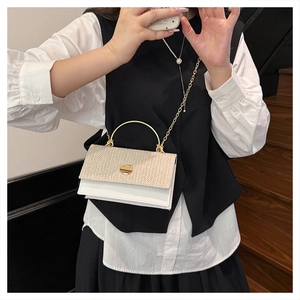 Chic women's crossbody bag with straw weave texture and white leather in a mirror selfie