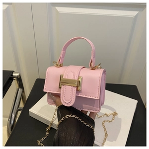 Detailed shot of pink PU leather handbag featuring gold chain and H-shaped metal clasp