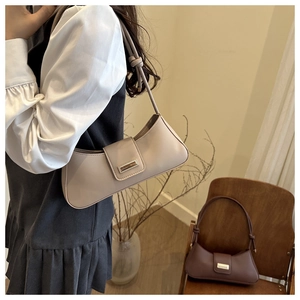 Close-up of retro PU leather baguette bags with knot handle detail and metal buckle