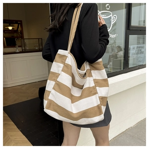 Detail view of the brown striped canvas tote bag showing thick durable fabric texture