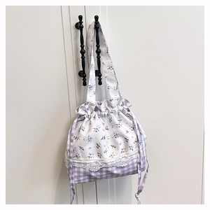 Close-up of floral drawstring bucket bag with purple gingham pattern and lace trim detail