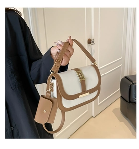 Details des weiß-braunen Satteltaschen-Sets mit geometrischer Metallschnalle und Tasche