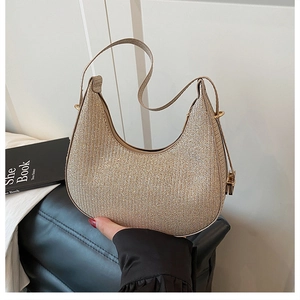 Macro detail of hobo shoulder bag featuring champagne gold sequins and metallic hardware