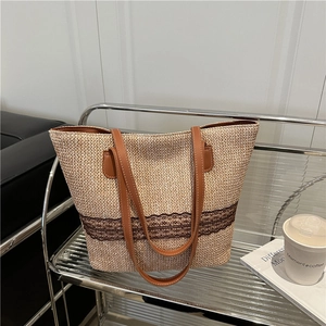 Minimalist straw woven tote bag with brown lace trim and faux leather shoulder straps