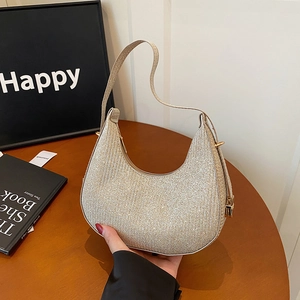 Sparkly champagne hobo bag with sequined texture and leather strap in a lifestyle setting