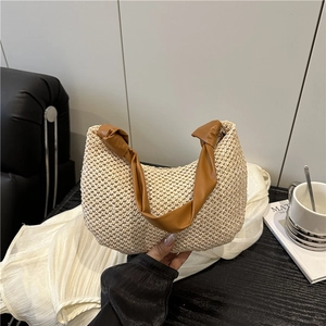 Chic woven hobo bag with brown knotted leather handle for summer beach travel