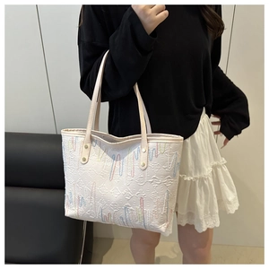 Detail of off-white tote bag with textured jacquard fabric and colorful wave embroidery
