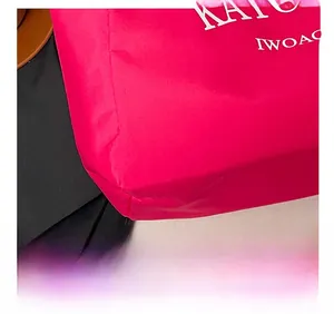 Detail view of pink tote bag with high-precision stitching and white printed letters