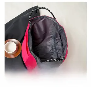 Top view of spacious rose red tote bag interior with durable black and white rope handles