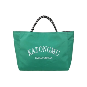 Vibrant emerald green tote bag with white lettering and woven rope handles on white background