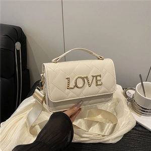 Cream quilted barrel bag with gold LOVE lettering and wide chain strap for daily wear