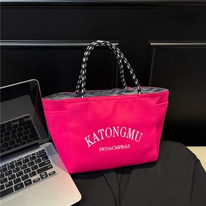 Vibrant pink canvas tote bag with letter print and stylish woven handles for daily use