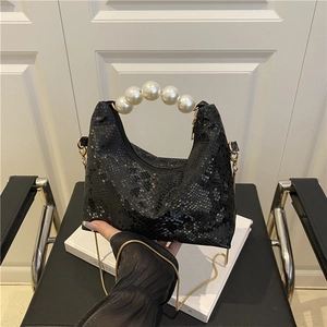 Chic black snakeskin embossed handbag with elegant pearl handle and gold chain strap