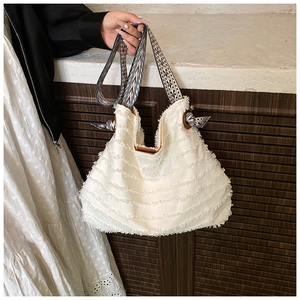 Détail du sac cabas blanc à franges avec large bandoulière aux motifs ethniques