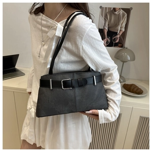 Detail of vintage grey leather tote bag showing shoulder strap and silver buckle hardware