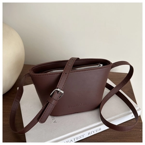 Chic dark brown leather bucket bag with adjustable strap and silver metal hardware
