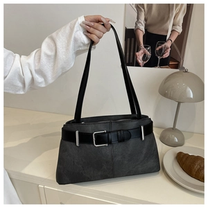 Detailed close-up of dark grey tote bag with black strap and silver buckle accent