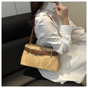 Detail of khaki suede tote bag with decorative dark brown leather belt and silver buckle