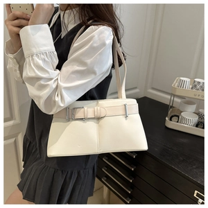 Close-up of cream PU leather shoulder bag with decorative buckle and silver hardware