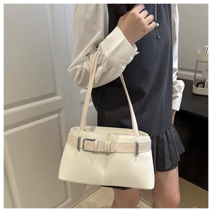 Detail of cream white PU leather tote bag featuring elegant decorative buckle and slim straps