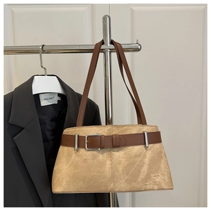 Detailed view of khaki suede tote bag with brown leather straps and metal buckle accent