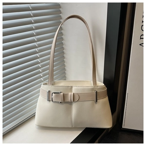 Detail of off-white leather underarm bag with silver buckle and trapezoidal structure