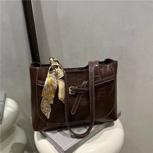 Brown crocodile embossed tote bag with contrast stitching and decorative silk scarf