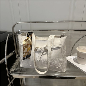 Minimalist white crocodile embossed tote bag with decorative silk scarf on handle