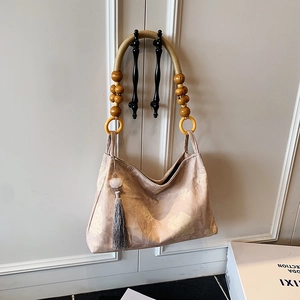 New Chinese style floral tote bag with wooden bead handle and tassel on a white door