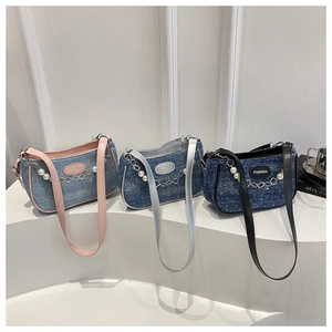Detailed comparison of denim shoulder bags in three blue washes with pearl chain decor
