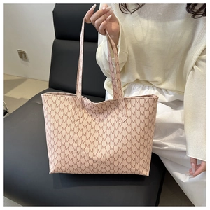 Detail of light pink large capacity tote bag featuring all-over M-letter logo pattern