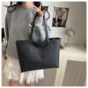 Detail of large tote bag with M-letter jacquard pattern and sturdy double handles