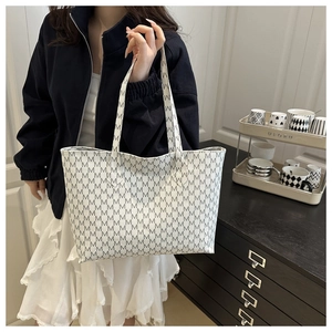 Detail of white tote bag with grey M letter print and comfortable double handles