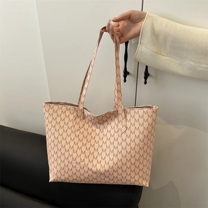 Large beige tote bag with M-letter monogram print and dual shoulder straps for commuting
