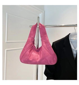 Detail of fuchsia tote bag showing diagonal stitching and matte suede texture