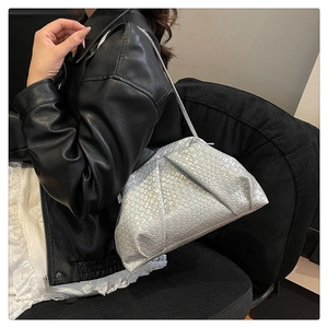 Chic silver woven cloud bag shown on shoulder with elegant metallic textured finish