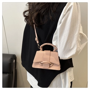 Detail of a mini pale pink crossbody bag with U-shaped buckle and decorative stitching