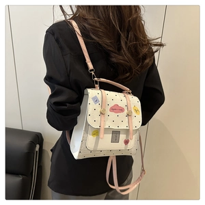 Polka dot mini backpack for women with pink straps shown on a model for casual daily use